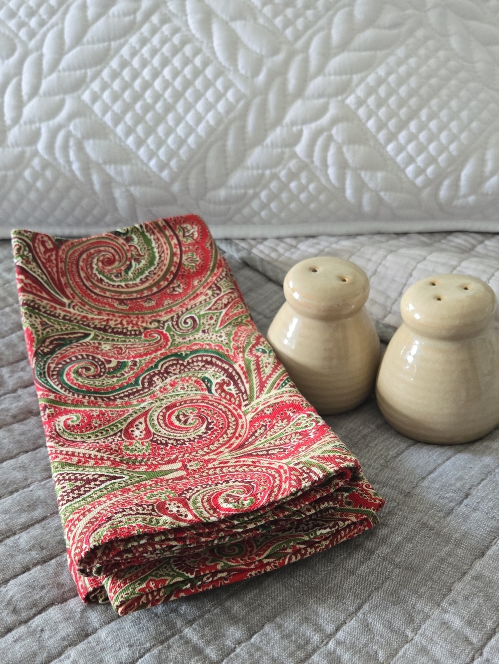Cotton Paisley Dinner Napkins - Red & Green. Paired with cream/tan shakers.